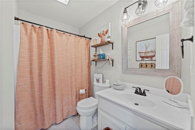 bathroom featuring toilet, curtained shower, and vanity