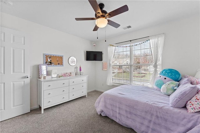 carpeted bedroom featuring visible vents, a ceiling fan, and baseboards