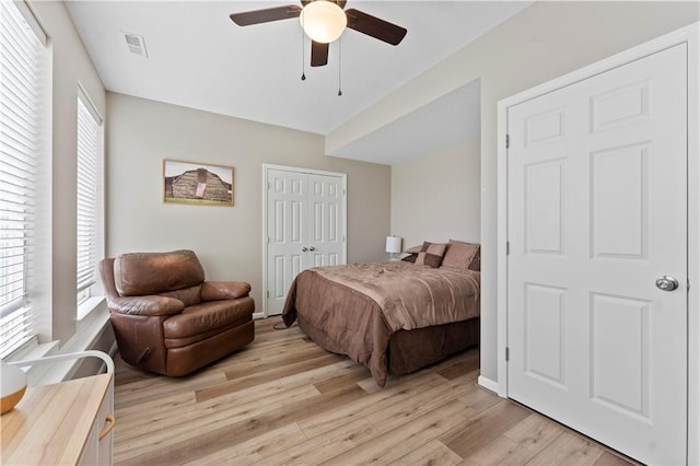 bedroom featuring ceiling fan, a closet, light wood-type flooring, and visible vents