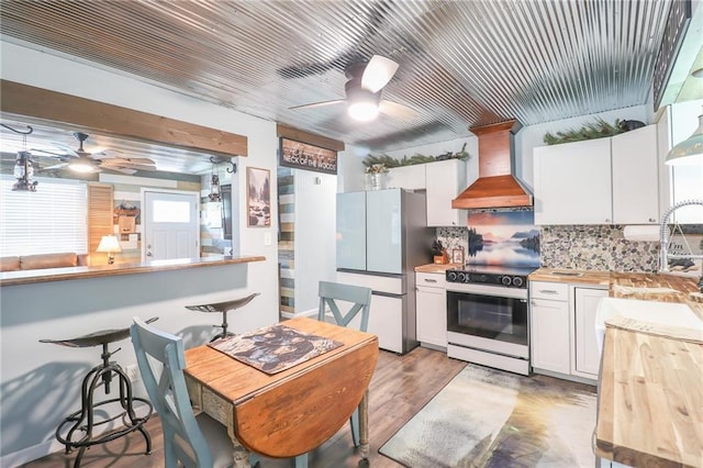 400 N Boardman St, Pleasant Hill, MO 64080 - kitchen featuring freestanding refrigerator, electric range, wooden counters, premium range hood, and a ceiling fan