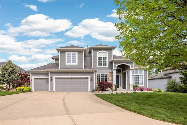 9924 Skyview Ln, Lenexa, KS 66220 - view of front of property with driveway, a front lawn, stucco siding, an attached garage, and a garage