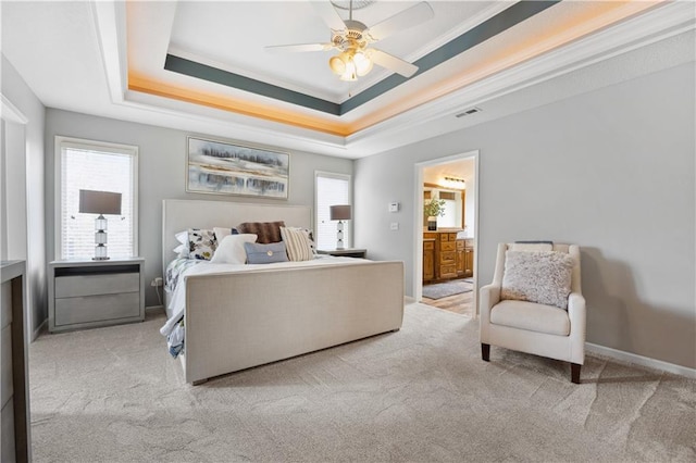 9924 Skyview Ln, Lenexa, KS 66220 - carpeted bedroom featuring a tray ceiling, crown molding, ensuite bathroom, a ceiling fan, and baseboards