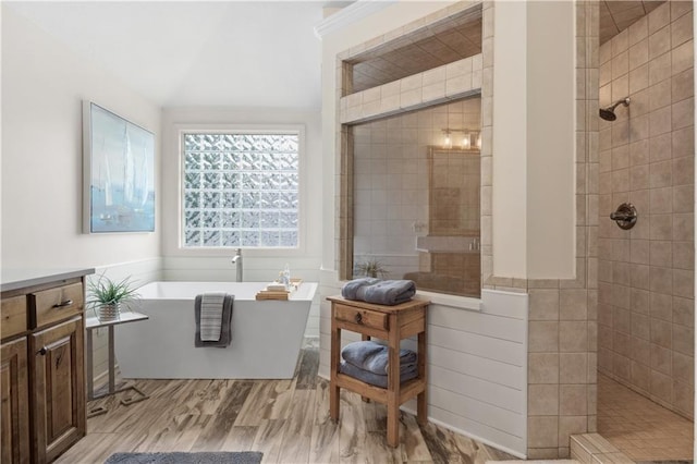 9924 Skyview Ln, Lenexa, KS 66220 - bathroom with a freestanding bath, a tile shower, wood finished floors, and vanity