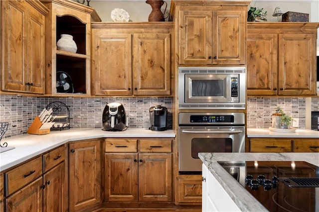 9924 Skyview Ln, Lenexa, KS 66220 - kitchen with stainless steel appliances, light countertops, and tasteful backsplash