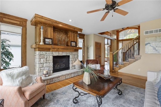 9924 Skyview Ln, Lenexa, KS 66220 - living room with a fireplace, wood finished floors, baseboards, a ceiling fan, and stairway