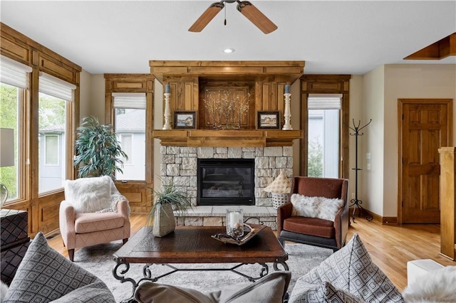 9924 Skyview Ln, Lenexa, KS 66220 - living room featuring light wood-style flooring, a ceiling fan, baseboards, and a fireplace