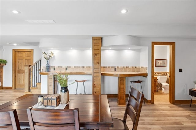 9924 Skyview Ln, Lenexa, KS 66220 - dining space with light wood-style floors, baseboards, stairs, and recessed lighting