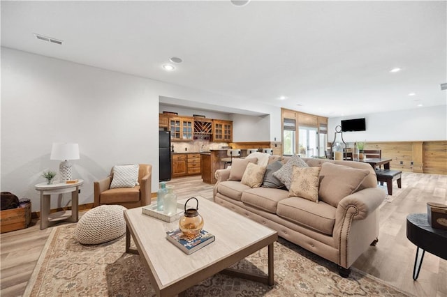 9924 Skyview Ln, Lenexa, KS 66220 - living room featuring light wood-type flooring, recessed lighting, and a bar
