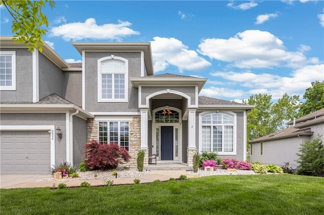9924 Skyview Ln, Lenexa, KS 66220 - view of front of house featuring stucco siding, a front lawn, stone siding, a garage, and concrete driveway