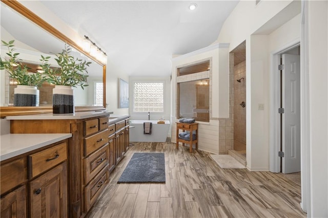 9924 Skyview Ln, Lenexa, KS 66220 - full bathroom featuring a walk in shower, vanity, a soaking tub, and wood finished floors