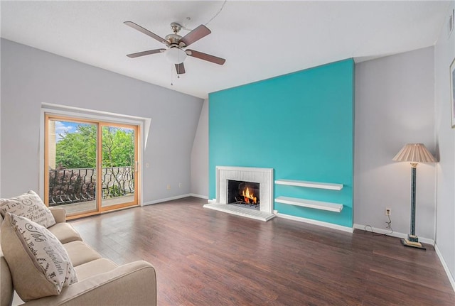living room with ceiling fan, a fireplace, baseboards, wood finished floors, and visible vents