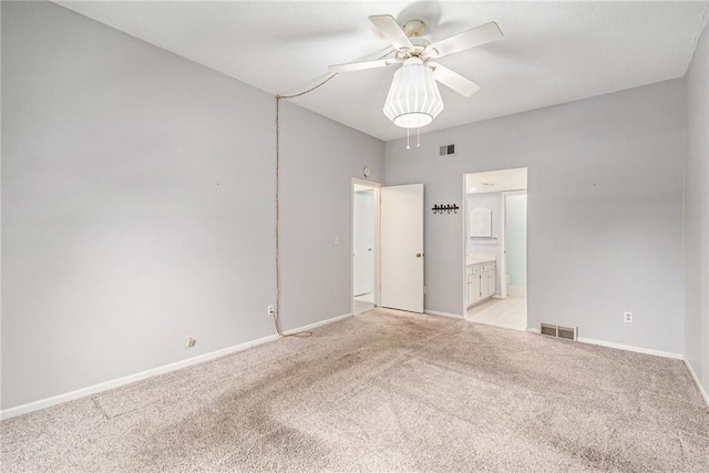 empty room featuring baseboards, light carpet, a ceiling fan, and visible vents