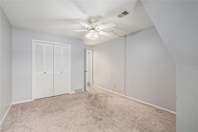 unfurnished bedroom with carpet floors, baseboards, a closet, and visible vents
