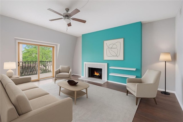 6724 W 109th St Unit F, Overland Park, KS 66211 - living area featuring wood finished floors, a warm lit fireplace, and ceiling fan