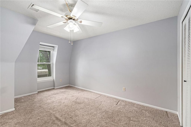 6724 W 109th St Unit F, Overland Park, KS 66211 - unfurnished bedroom featuring carpet floors, a closet, a textured ceiling, and a ceiling fan