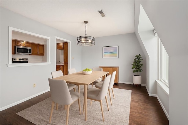 6724 W 109th St Unit F, Overland Park, KS 66211 - dining space featuring a chandelier and dark wood-style flooring