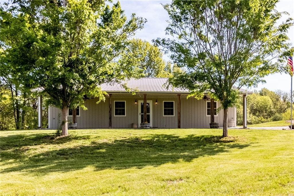 105 NW 1050th Rd, Warrensburg, MO 64093 - rear view of property with a porch, a lawn, and metal roof