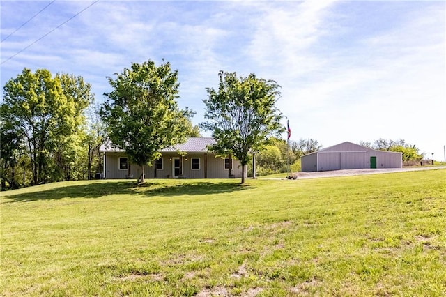 view of green lawn with a garage, an outbuilding, and an outdoor structure