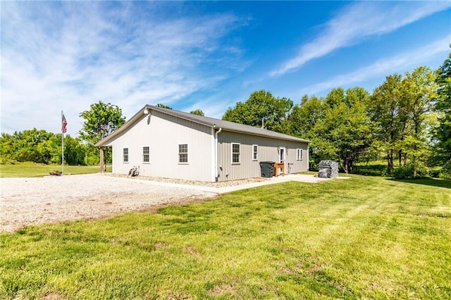 back of property featuring a lawn