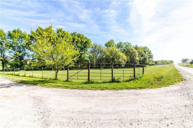 view of dirt / gravel road featuring a view of rural / pastoral area