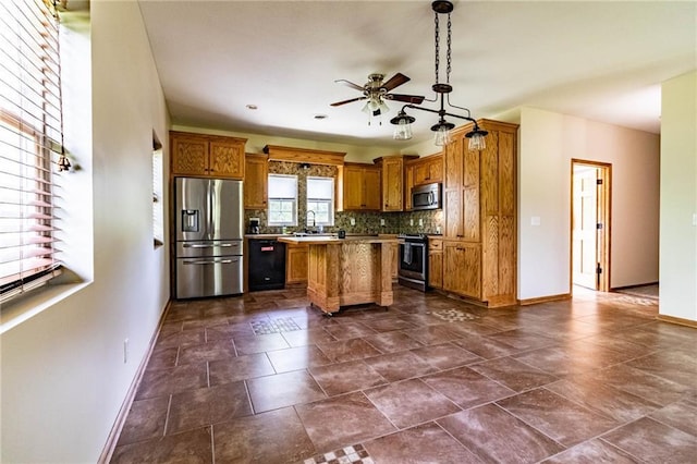 kitchen featuring stainless steel appliances, baseboards, ceiling fan, and brown cabinets
