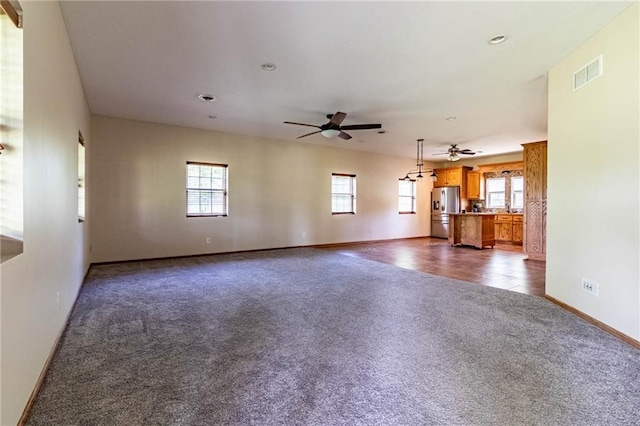 unfurnished living room featuring dark carpet, ceiling fan, baseboards, and recessed lighting