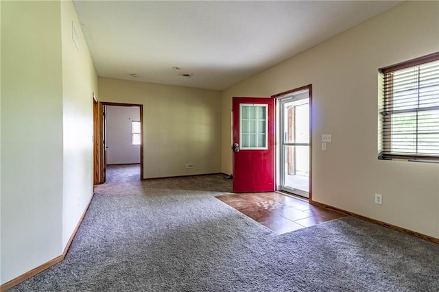 carpeted empty room with baseboards