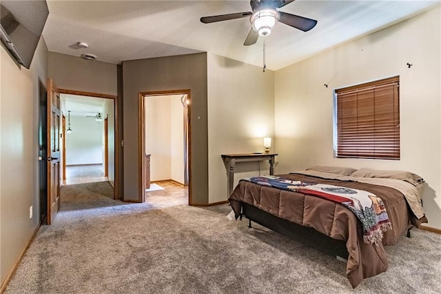 carpeted bedroom with baseboards and ceiling fan