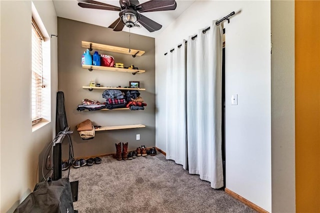 interior space featuring a ceiling fan and baseboards