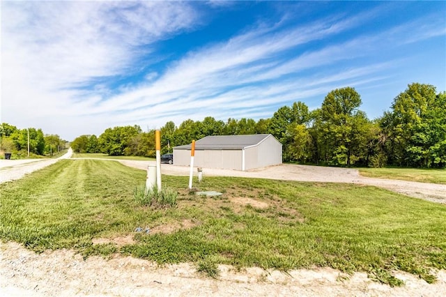 view of green lawn featuring an outbuilding and an outdoor structure