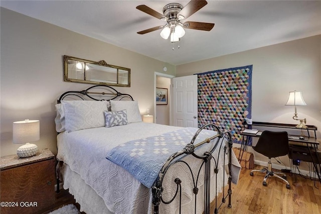 bedroom with baseboards, ceiling fan, and wood finished floors