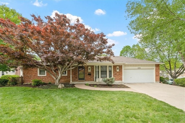 single story home with brick siding, a garage, driveway, and a front yard