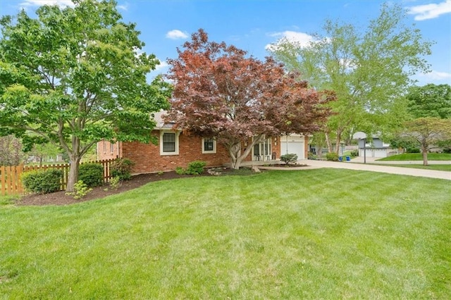 view of front facade featuring a garage, a front lawn, fence, brick siding, and concrete driveway