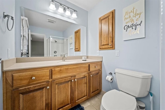 bathroom with visible vents, vanity, toilet, tile patterned floors, and a shower stall