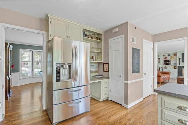 9817 Cedar St, Overland Park, KS 66207 - kitchen featuring stainless steel fridge with ice dispenser, open shelves, light wood-style flooring, built in features, and baseboards
