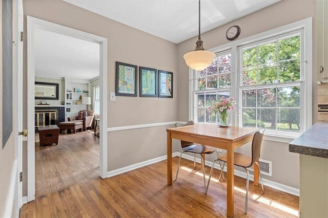 9817 Cedar St, Overland Park, KS 66207 - dining area with wood finished floors, plenty of natural light, baseboards, and a fireplace