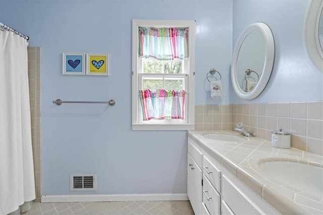 9817 Cedar St, Overland Park, KS 66207 - bathroom featuring double vanity, curtained shower, and baseboards