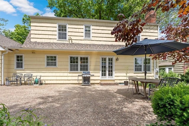 9817 Cedar St, Overland Park, KS 66207 - back of house featuring a shingled roof and a patio area