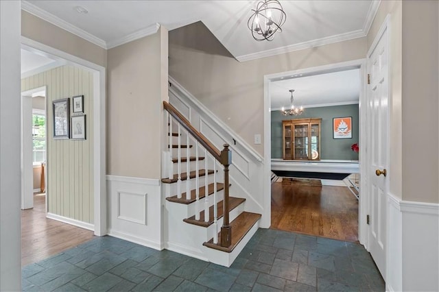 9817 Cedar St, Overland Park, KS 66207 - staircase with a chandelier, stone tile floors, and crown molding