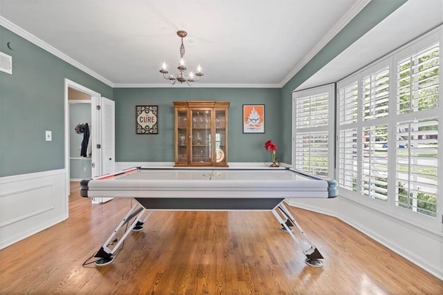 9817 Cedar St, Overland Park, KS 66207 - recreation room with a chandelier, ornamental molding, wood finished floors, and a wainscoted wall