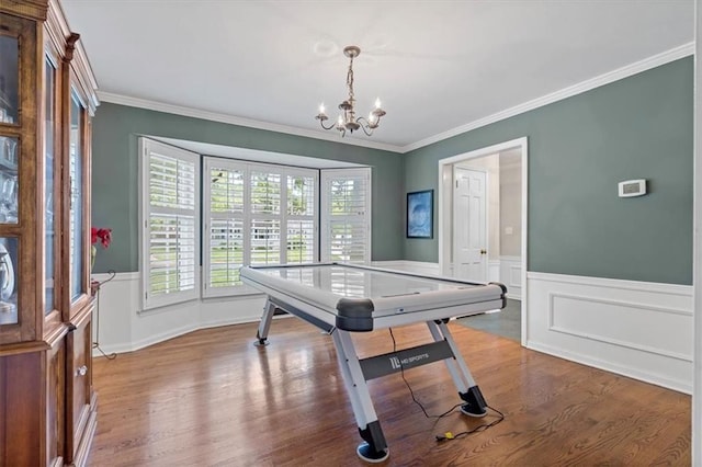 9817 Cedar St, Overland Park, KS 66207 - playroom with wood finished floors, a chandelier, ornamental molding, and wainscoting