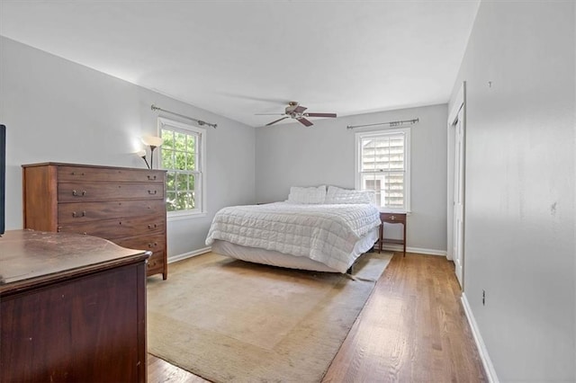 9817 Cedar St, Overland Park, KS 66207 - bedroom featuring light wood finished floors, baseboards, ceiling fan, and a closet