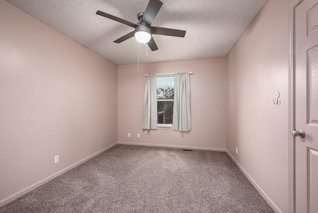 empty room featuring baseboards, carpet, a ceiling fan, and a textured ceiling