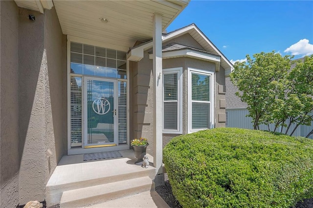 property entrance with stucco siding