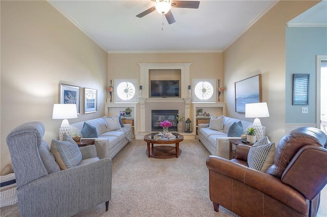 carpeted living area featuring ceiling fan, crown molding, and a glass covered fireplace