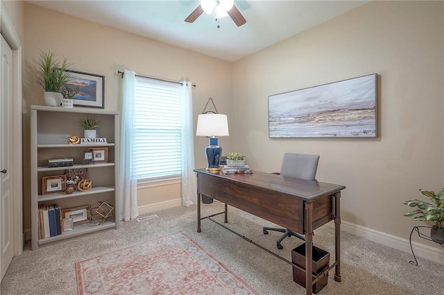 home office with baseboards, a wealth of natural light, ceiling fan, and carpet
