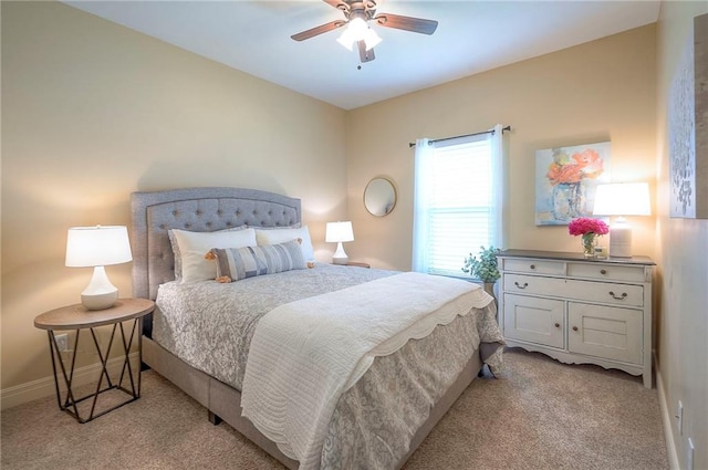 bedroom with light colored carpet, baseboards, and ceiling fan