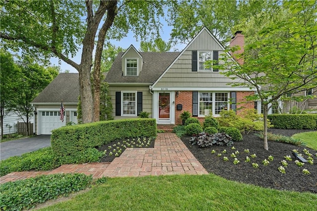 6116 W 61st Ter, Mission, KS 66202 - view of front of house featuring a garage, asphalt driveway, a chimney, brick siding, and a shingled roof