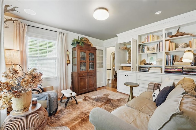 6116 W 61st Ter, Mission, KS 66202 - living area featuring wood finished floors, arched walkways, and crown molding