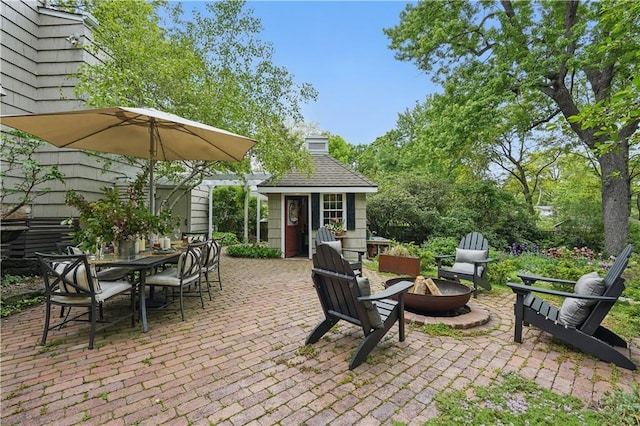 6116 W 61st Ter, Mission, KS 66202 - view of patio / terrace with a fire pit, an outdoor structure, and outdoor dining space